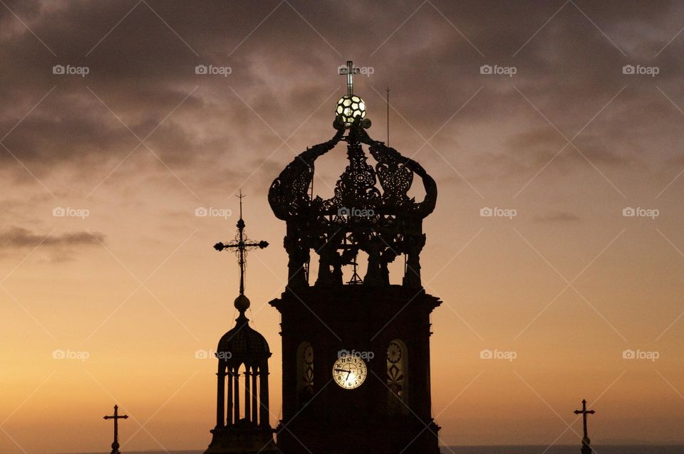 The steeple of the Parroquia de Nuestra Señora de Guadalupe Catholic Church in Puerto Vallarta, Mexico at sunset.