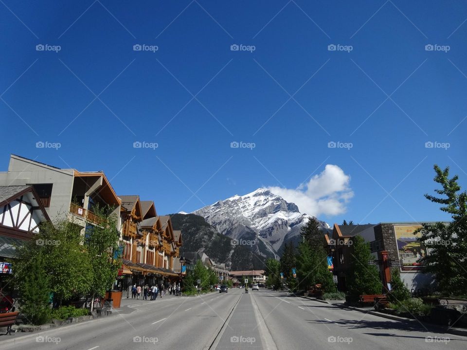 Mountain Town Charm: Canmore’s Scenic Street View with Mountains and Blue skies 