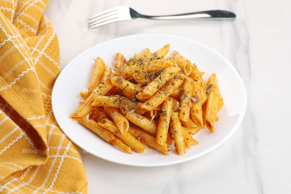 Penne Pasta food on white marble background