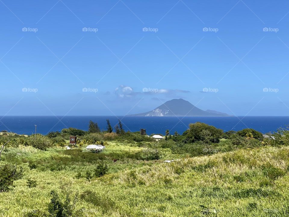 Looking across a grassy expanse across the Caribbean towards Nevis 