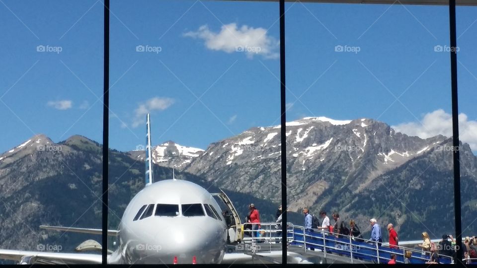 People Boarding Plane in the Mountains