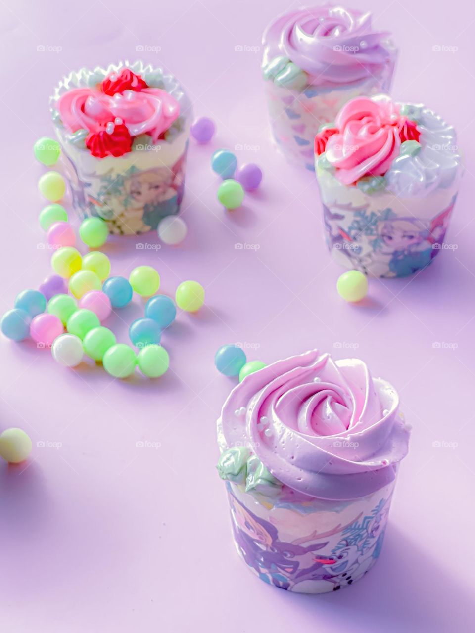 Colourful cupcakes and candies on top of a table