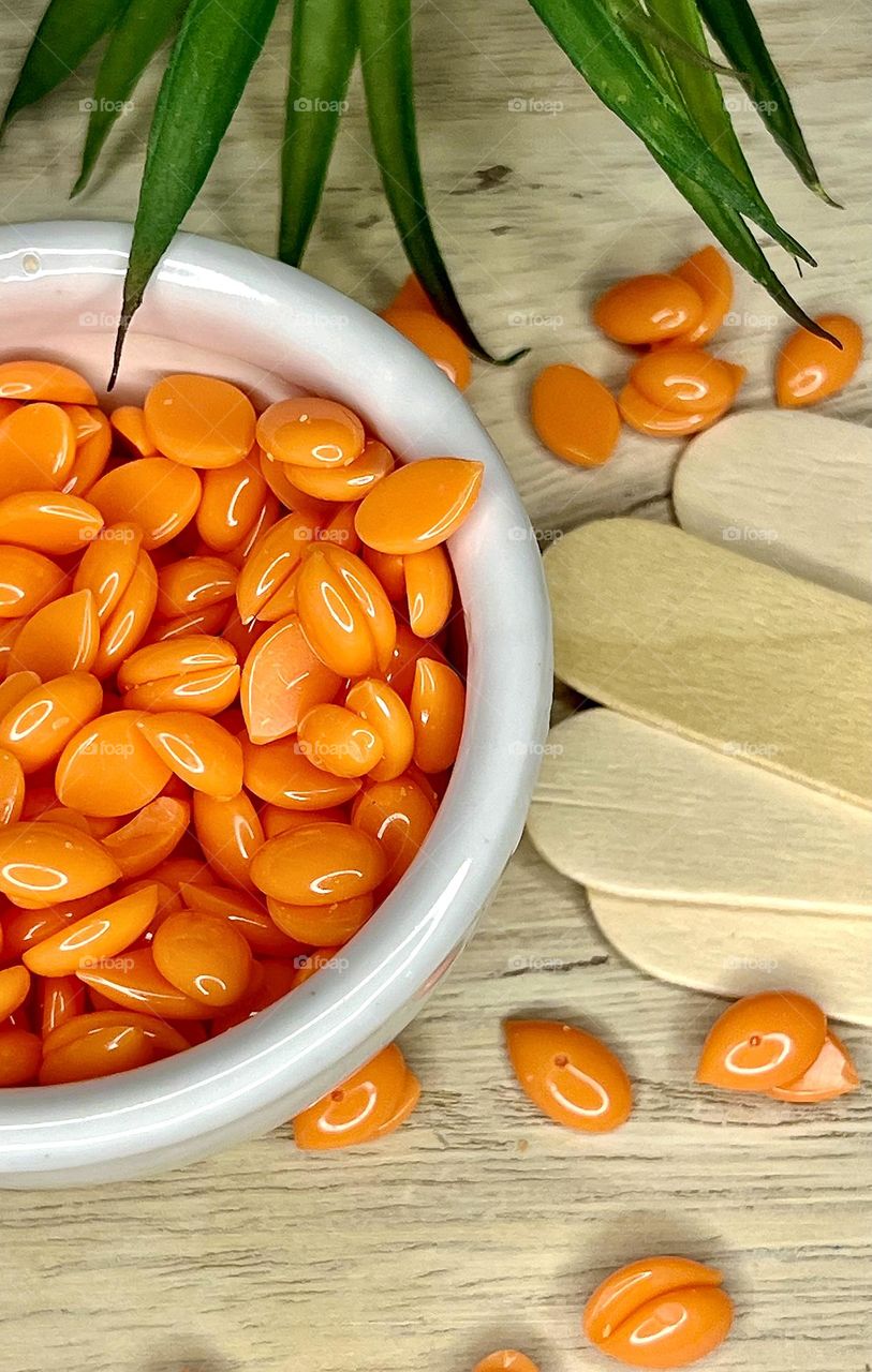 Depilatory wax in a white ceramic container