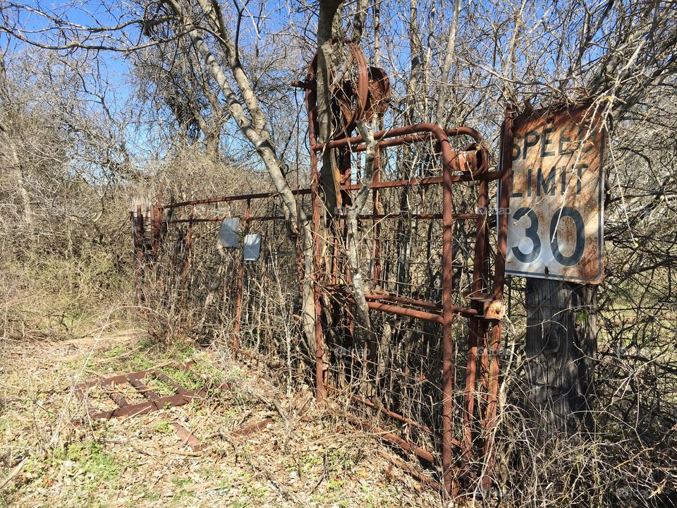 Old rolling gate and road sign. 