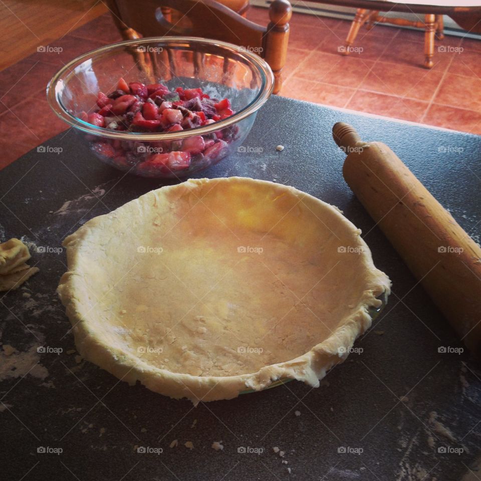 Baking a berry pie. Pie crust, pastry, rolling pin, bowl of berries