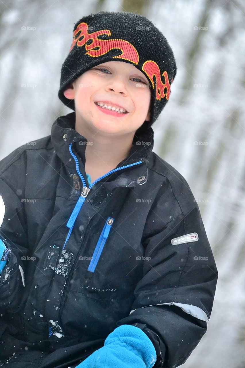 Happy boy outside in the snow