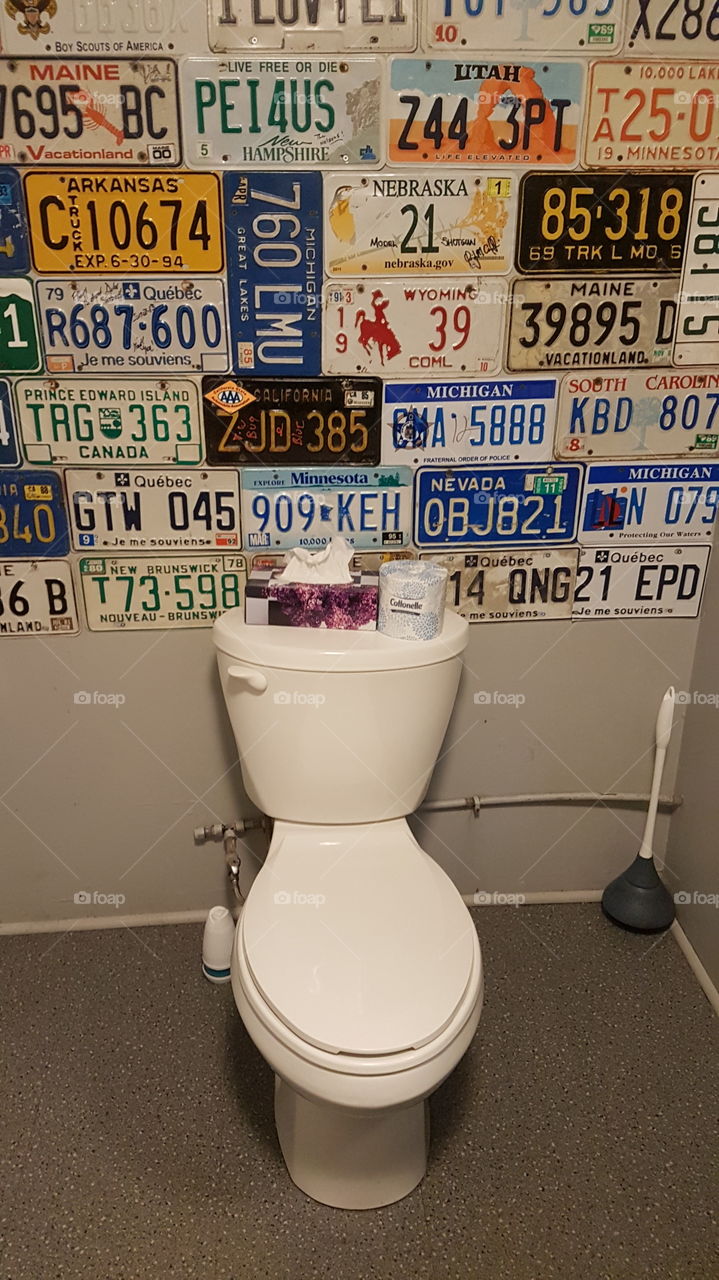 A well-decorated restroom with numberplates from all over the world at the Chowder House restaurant in Point Prim, P.E.I., Canada