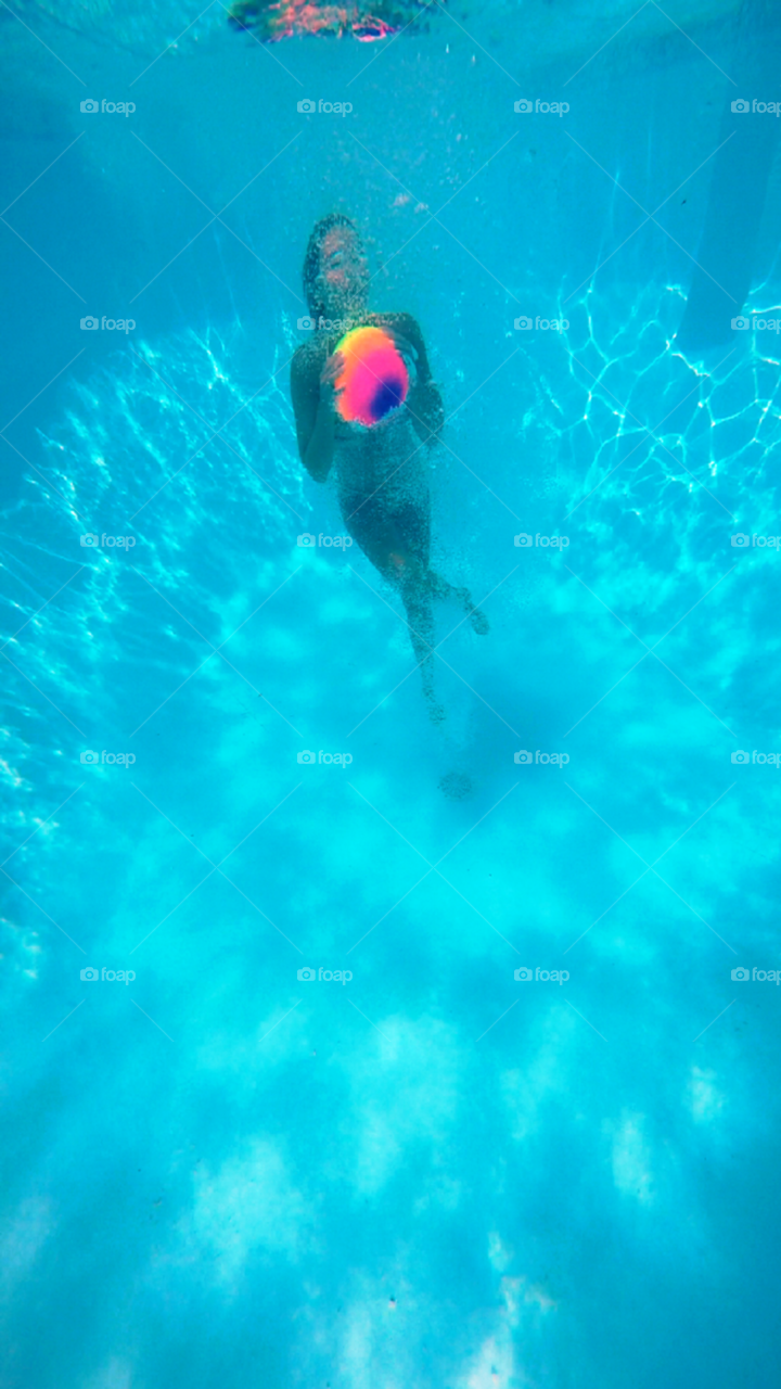 Young woman swimming underwater