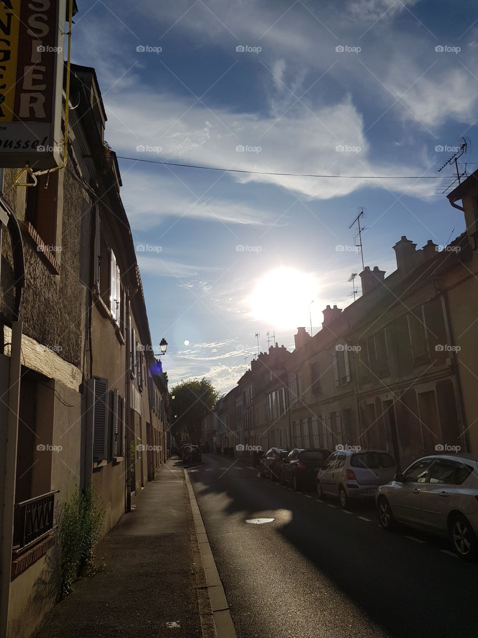 the sun with clouds on the sky