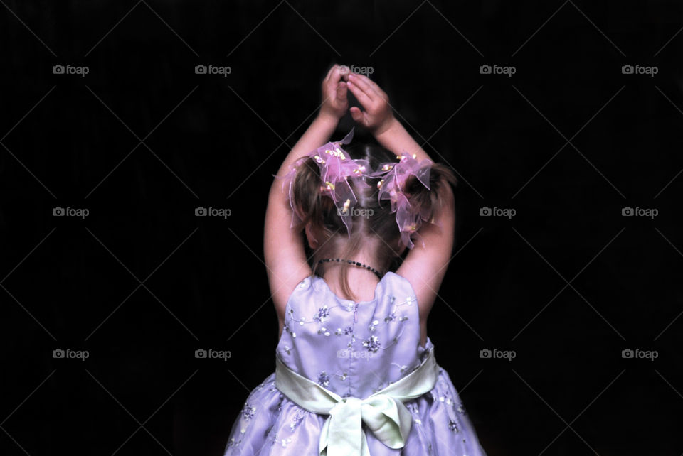 A little girl dancing at a wedding