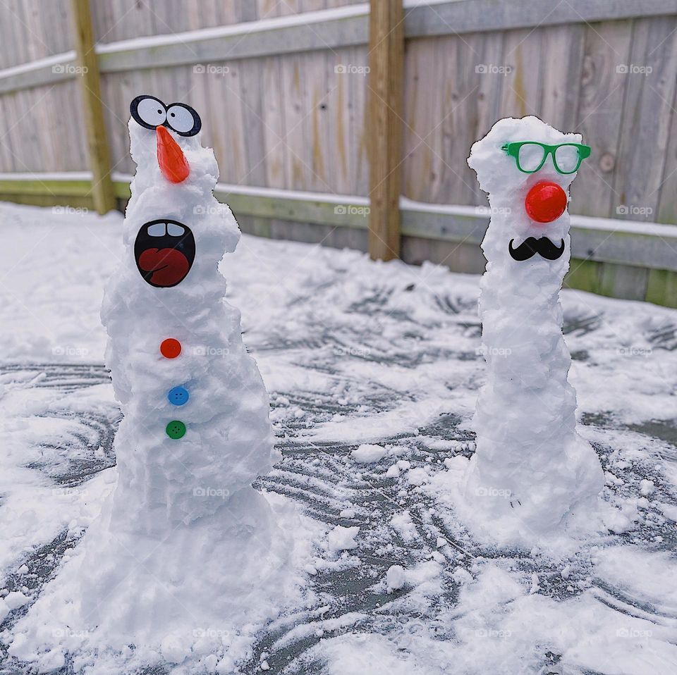 Snowmen outside in the winter, building snowmen in the cold, winter activities with toddlers, building snowmen, snowman kits 