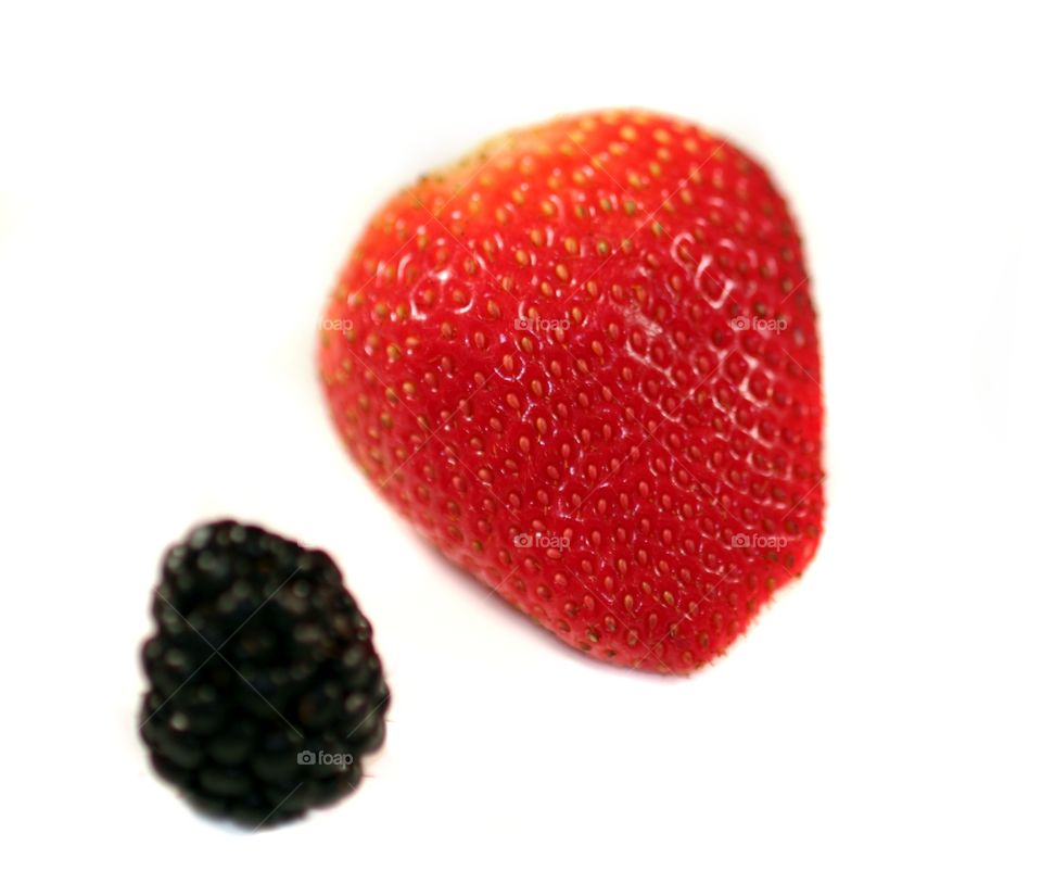 Strawberry Blackberry
Red strawberry with blackberries on white or light background.