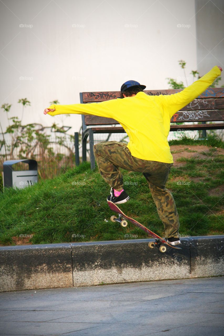 Skateboarder practising his skills in sort of... unusual place.