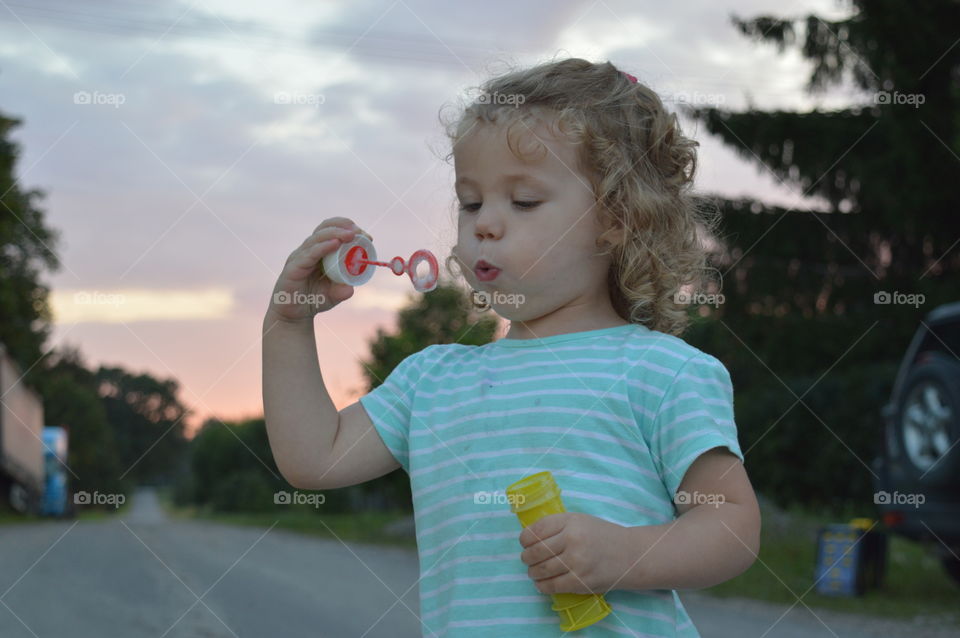 Girl blowing bubble wand
