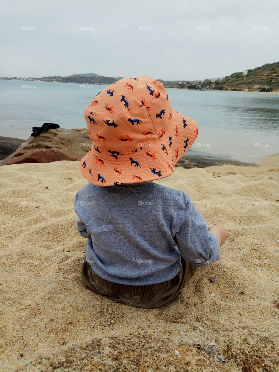 baby on the beach in summer time with a hut