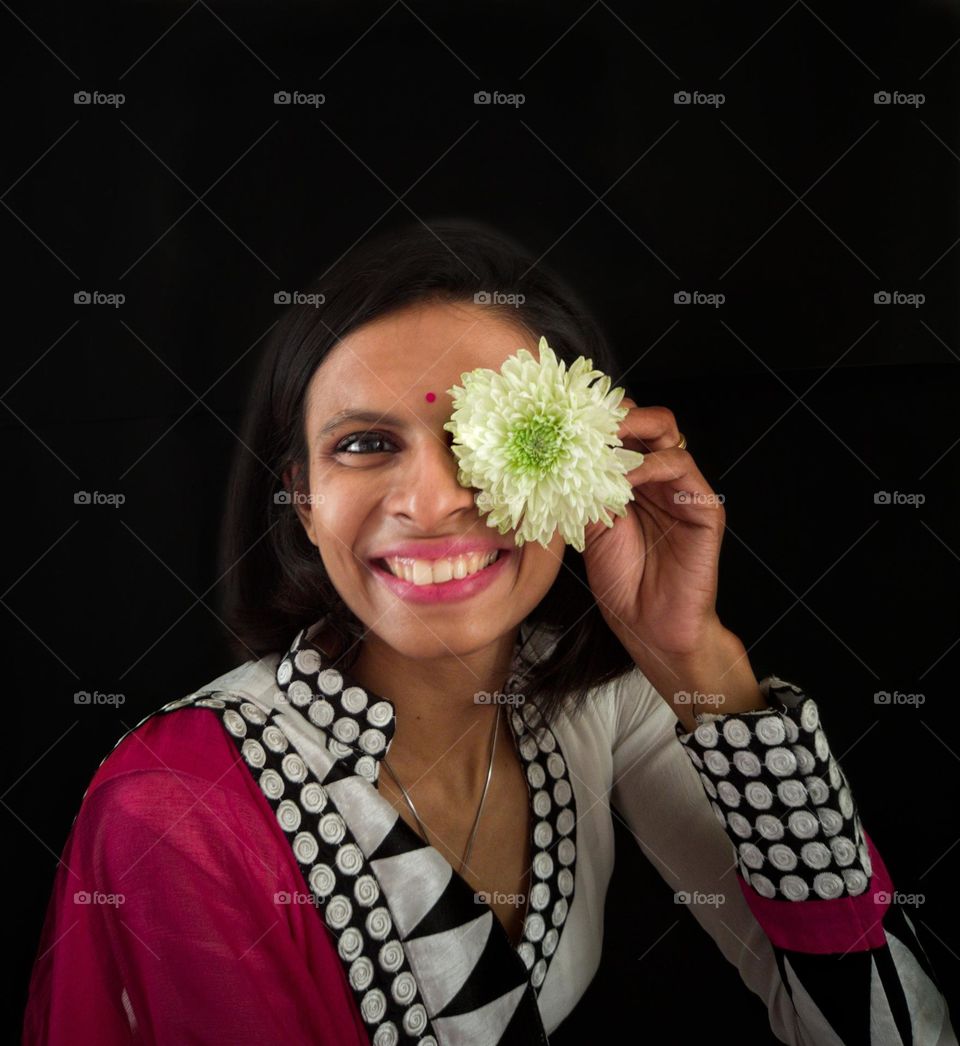 Smiling Face
Young girl with blooming smile & Flower