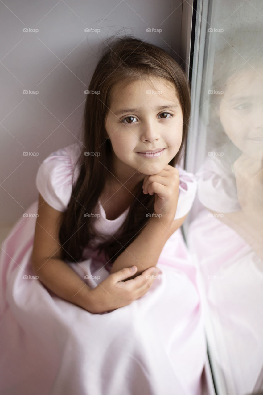 Girl sitting near window