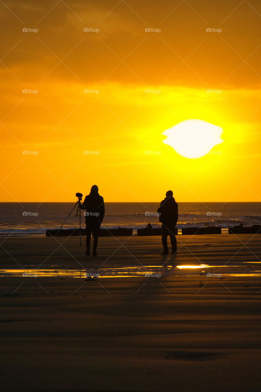 silhouettes at dawn on the beach