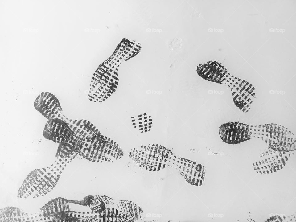 many footprint on white floor.
