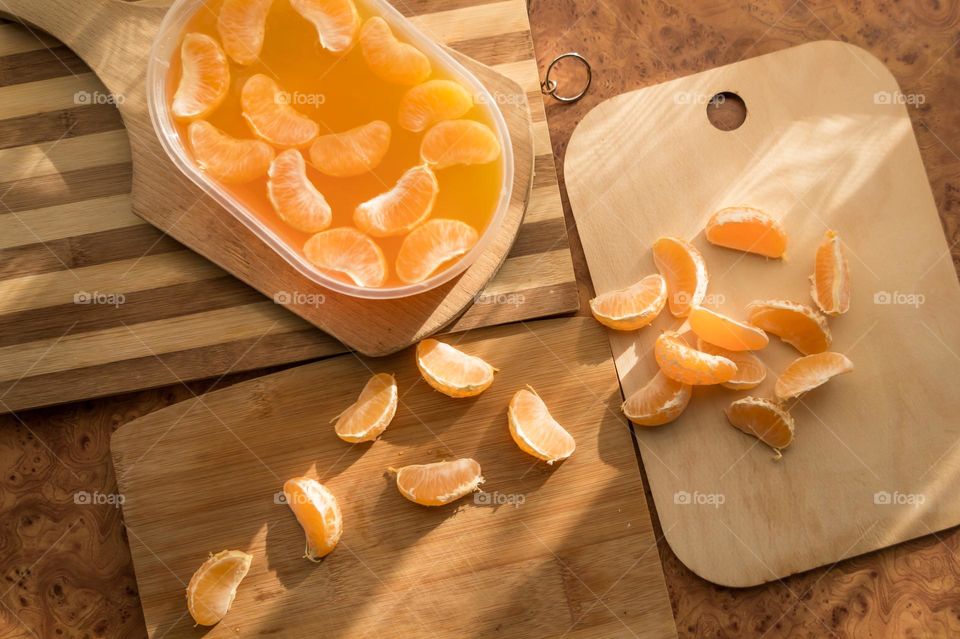 Delicious orange jelly with tangerine slices in a container and jelly worms.
