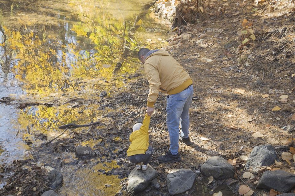 Back view of little boy and his father