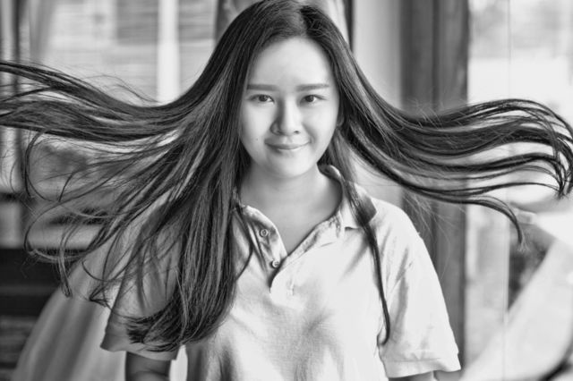 Portrait of a woman with her hair swept by wind