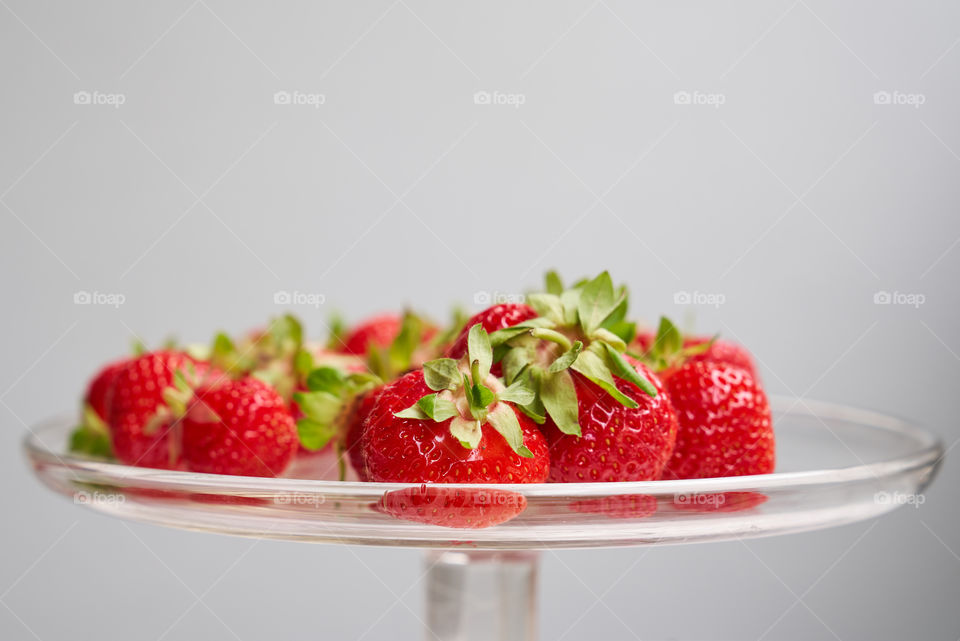 Fresh red strawberries on glass plate