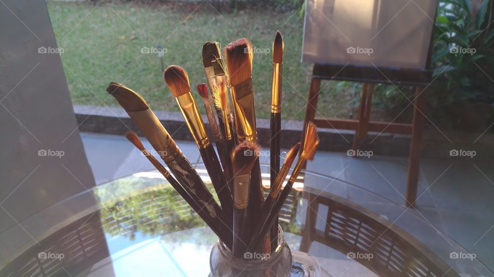 Paint brushes on glass table