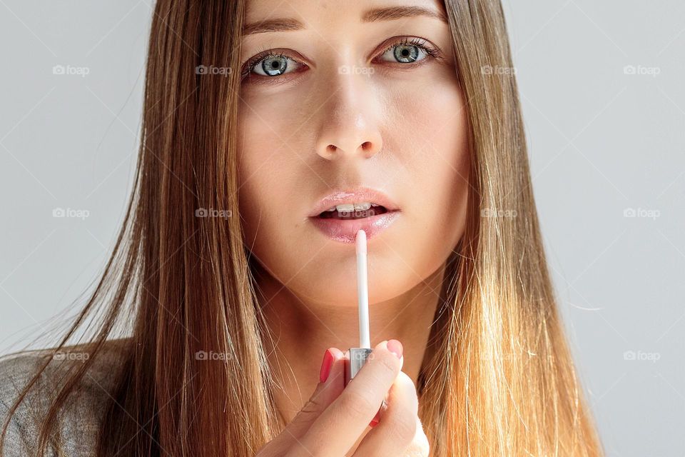 Portrait of beautiful young woman with lipstick 