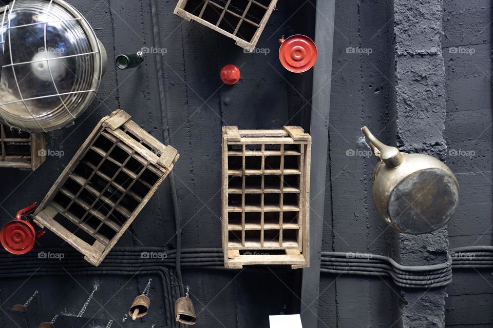 Ceiling decorated with bottles , lamp and wooden boxes