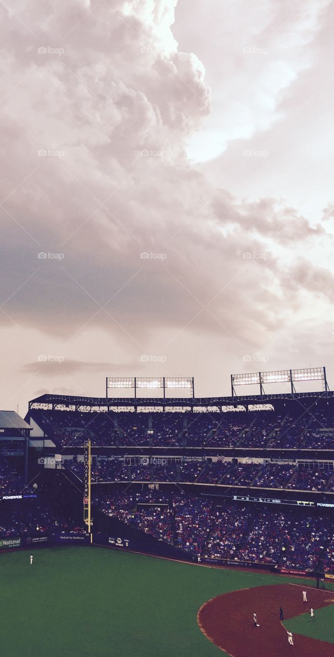 Endless Summer Baseball Game with Storm Clouds