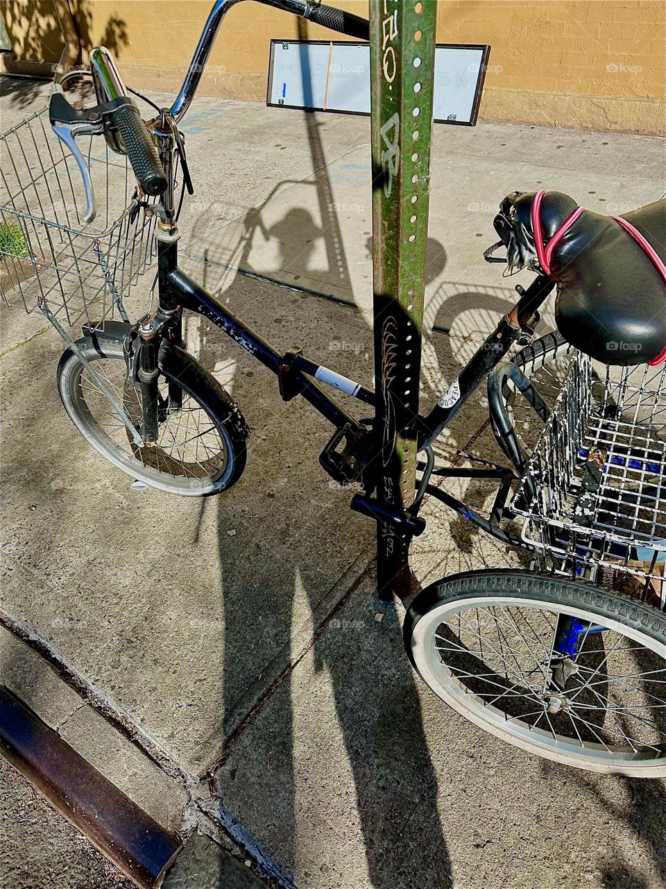 This mix of shapes and patterns, of overlapping shadows and real objects shows me photographing a bicycle on the sidewalk of “Jefferson St” off “Broadway” in “Bushwick”, Bklyn. The beauty of this image is in the assembly. 2024. Hypnotic Productions