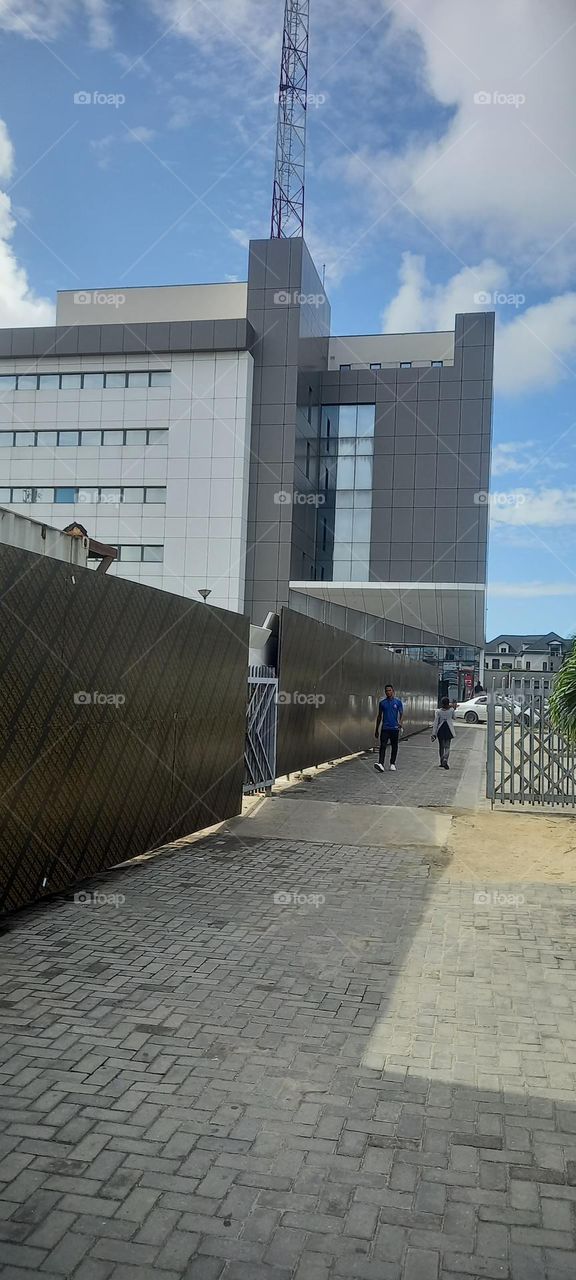 Lovely tall modern office building with a view of the big blue sky. A beautiful sight.