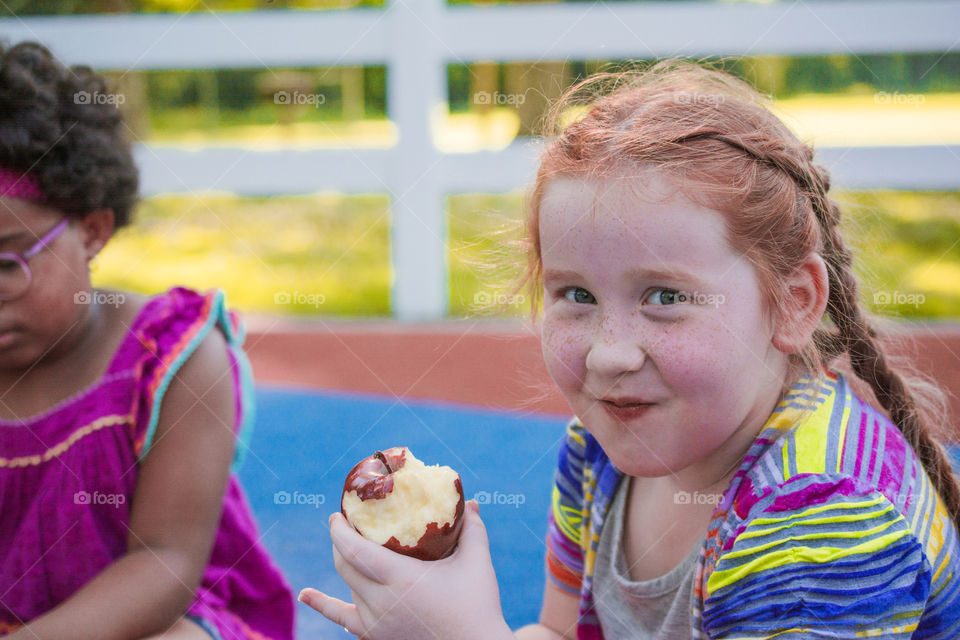 Young Girl Eating an Apple at the Park 3