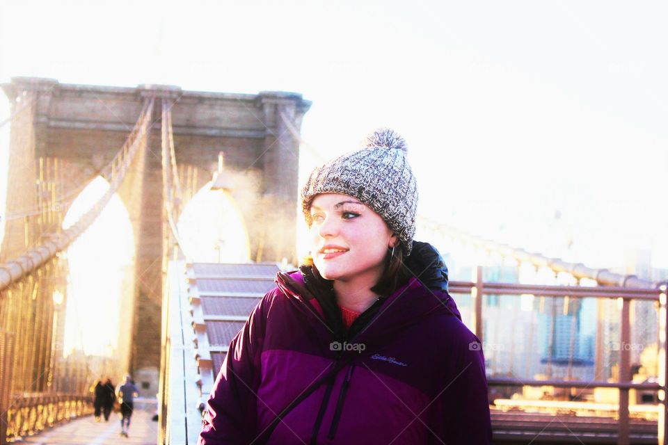 visible morning breath on the Brooklyn bridge with the girl wearing a winter cap