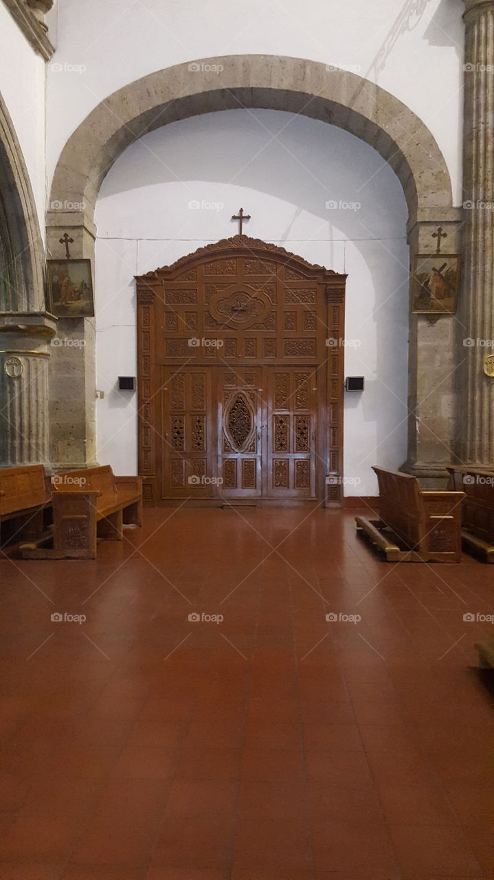 This wooden entryway was to one side of the main church. Unknown what it leads to. taken in a church in Guadalajara.