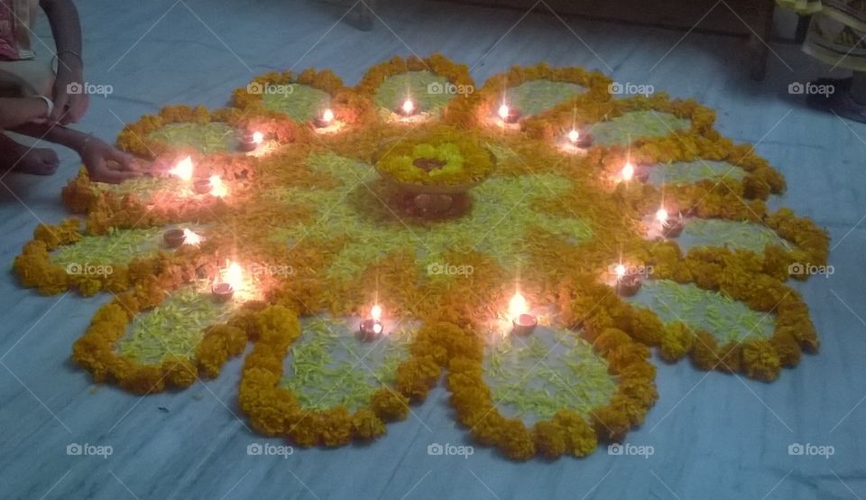 Diya 
Diyas 
Light
Flowers 
Decorates floor 
