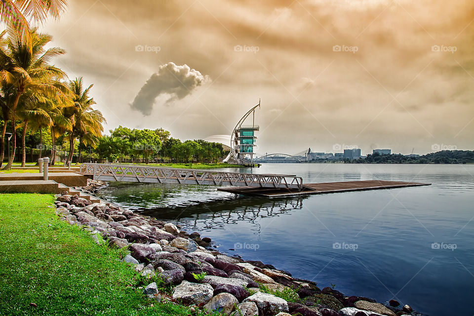 Pier on lake with cityscape in background