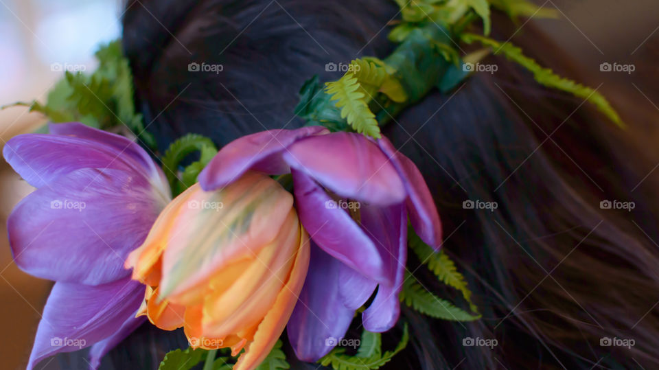 Wearing a flower crown garland made of tulips and fresh fern for wedding or summer celebration 