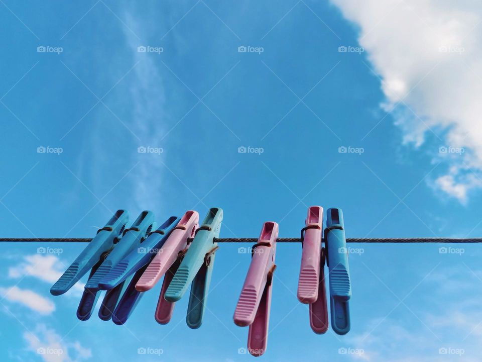 hanging clothespins against the blue sky.