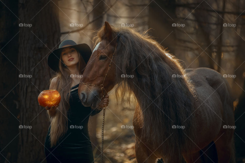 Beautiful woman portrait with horse. Halloween theme