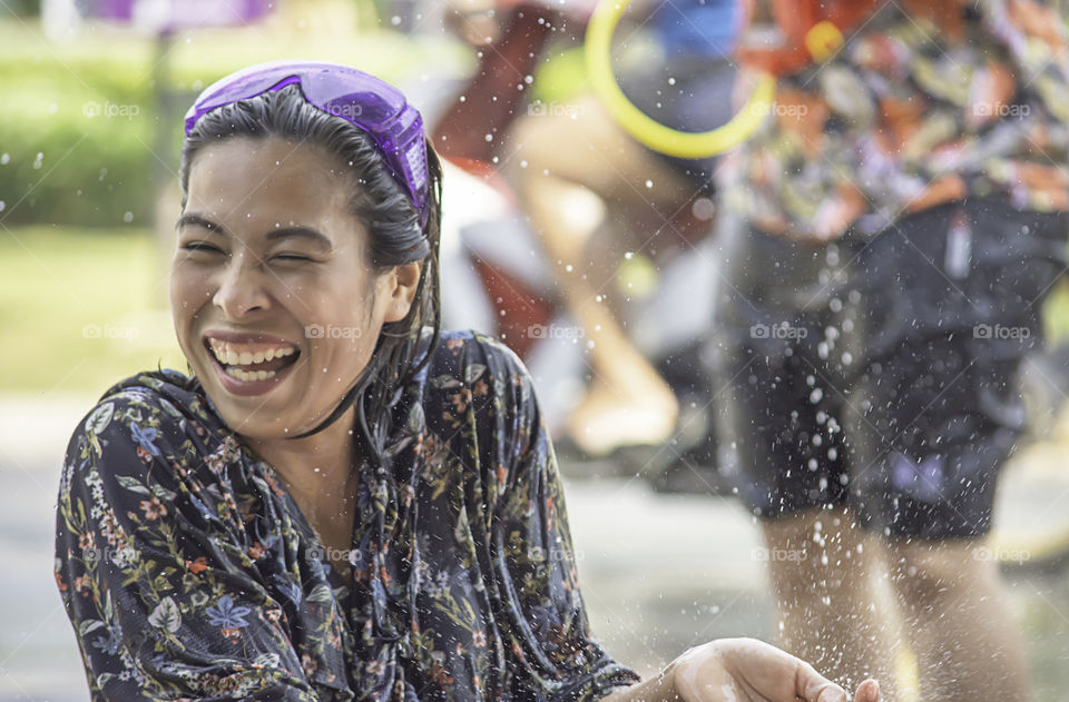 Asian woman play water in Songkran festival or Thai new year in Thailand.