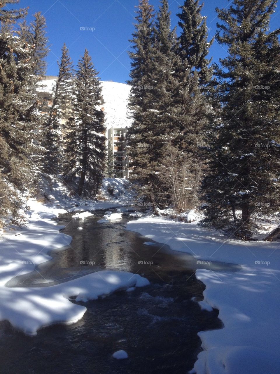 Frozen river by the winter mountain