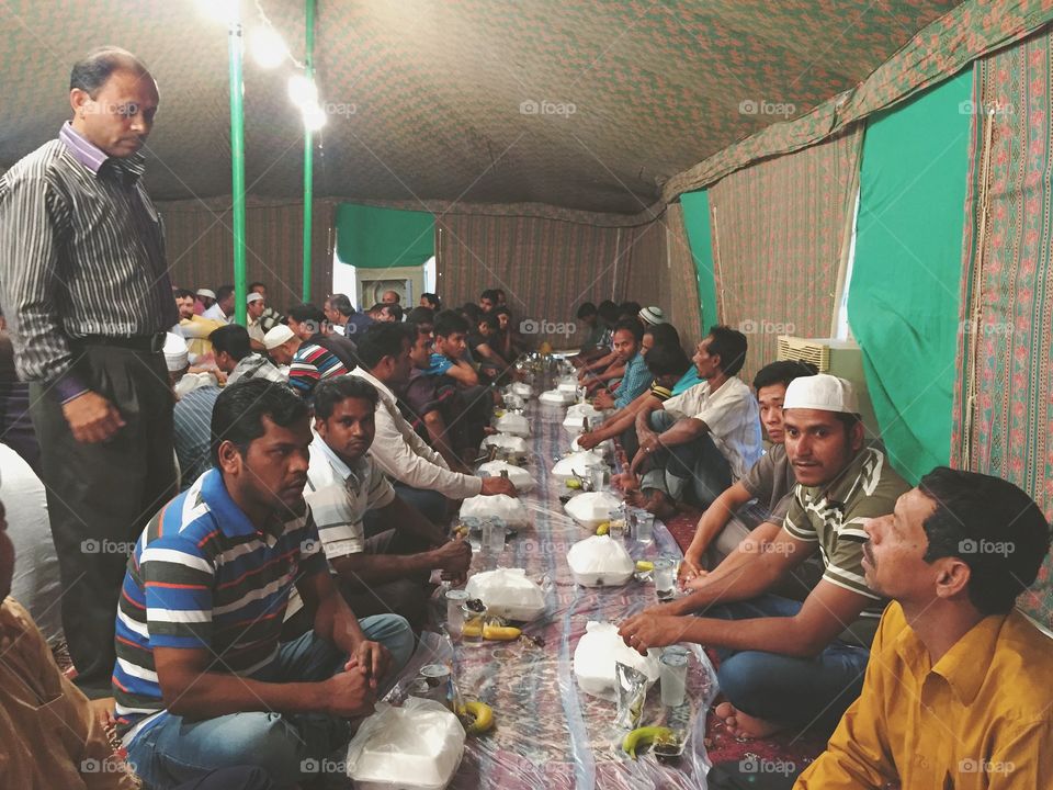 Iftar Tent, Riyadh, Saudi Arab. Labours getting ready to break their fast . Muslims fast in the month of Ramadan and break their fast at sunset.