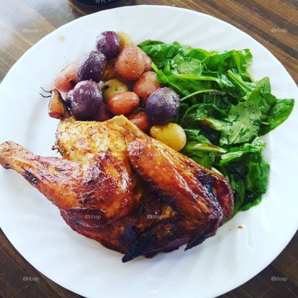 Beer can chicken with potatoes and salad