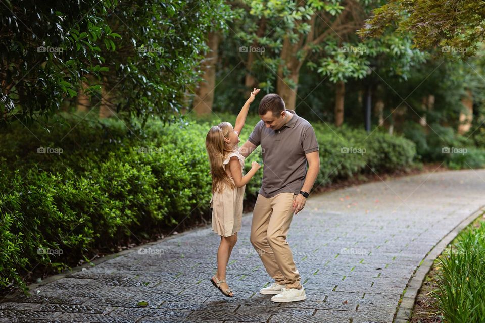 Happy father playing with daughter 