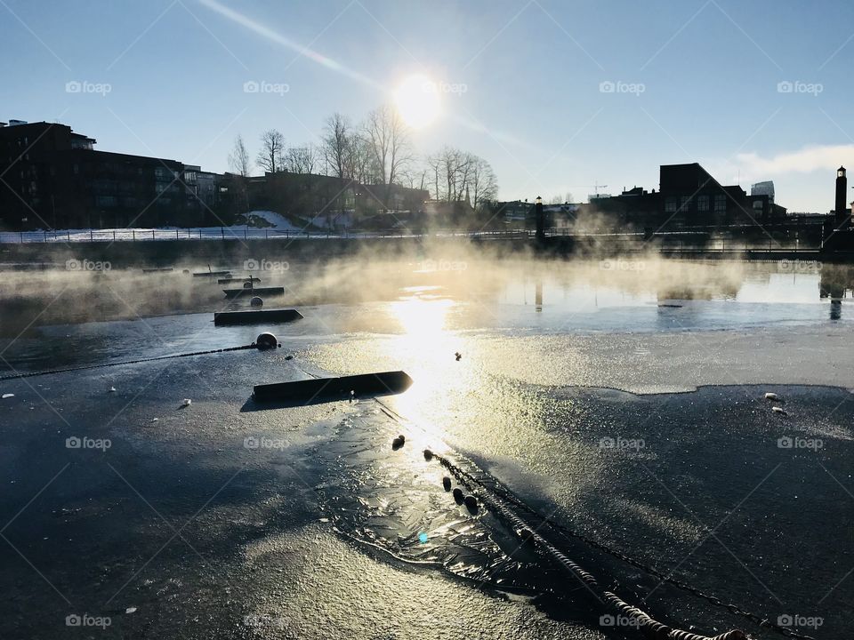 Frozen river in sunrise on a cold morning 