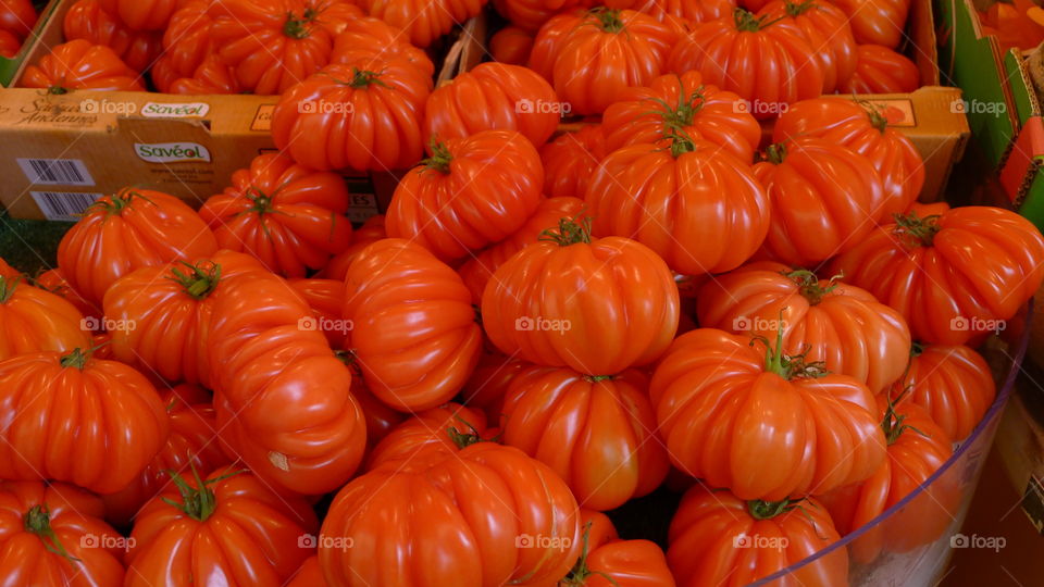 Delicious tomatoes in bright red on display in French Sunday market in France,excellent food photography 