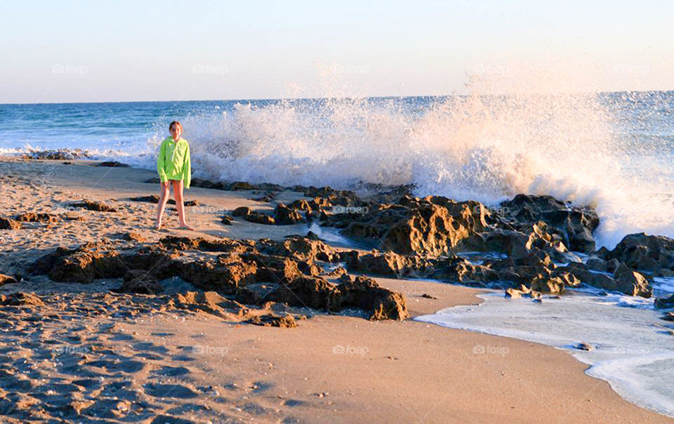 Bathtub beach. Young girl braves the crashing waves at Bathtub Beach, Florida