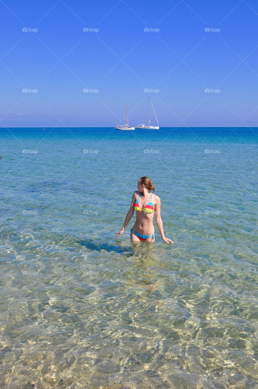 Swimming on Mediterranean Sea Sardinia island view 